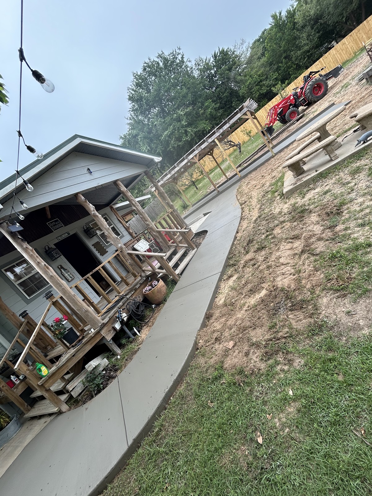 Curved concrete sidewalk running beside a house