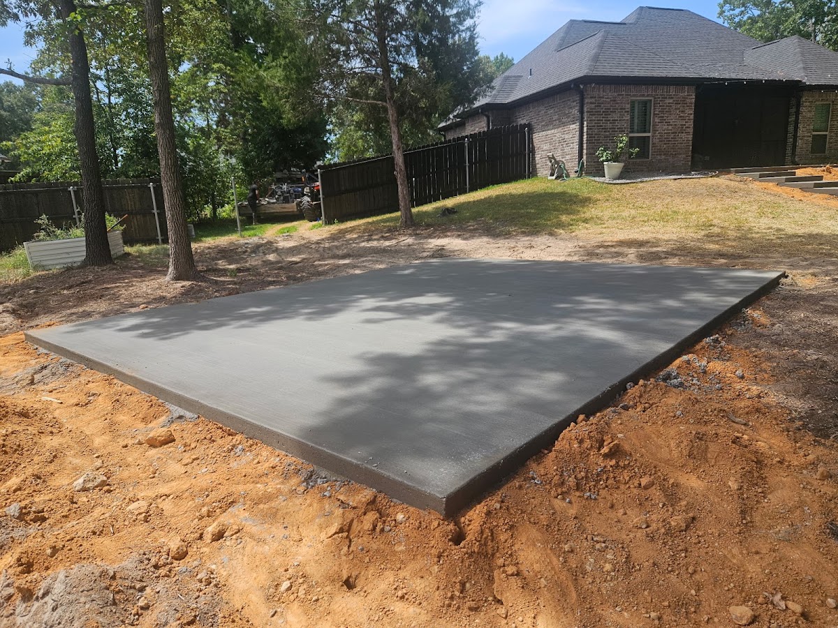 Fresh square concrete slab in a backyard