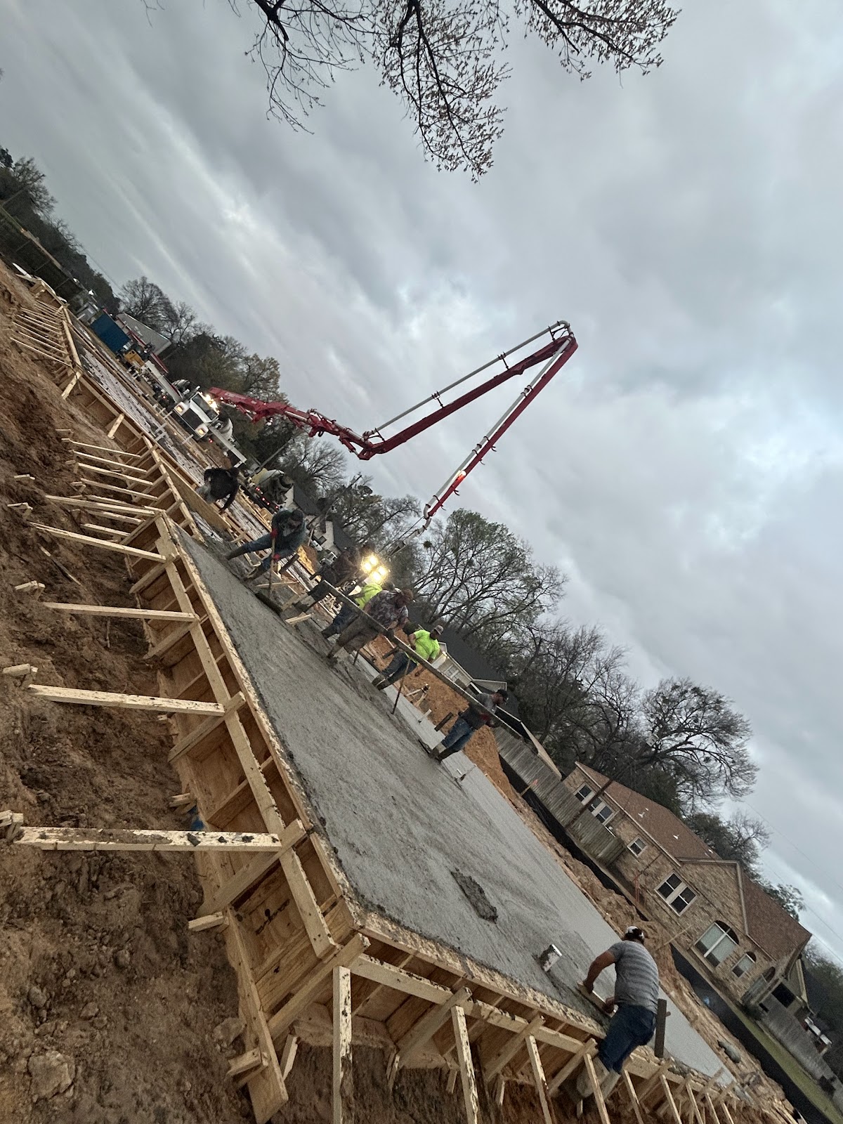 HBR crew spreading concrete from the pump hose into foundation forms